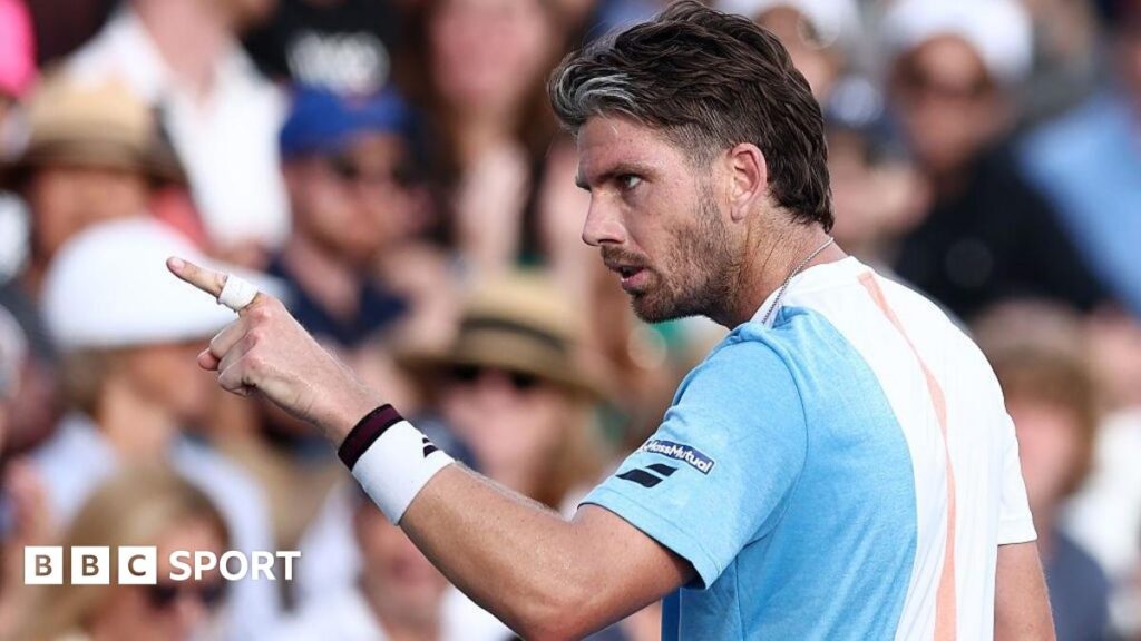 Cameron Norrie points at the crowd