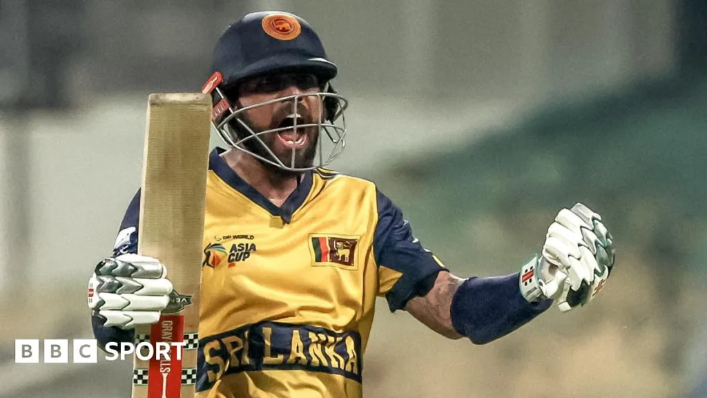Kusal Mendis celebrates Sri Lanka's qualification by holding his bat and cheering