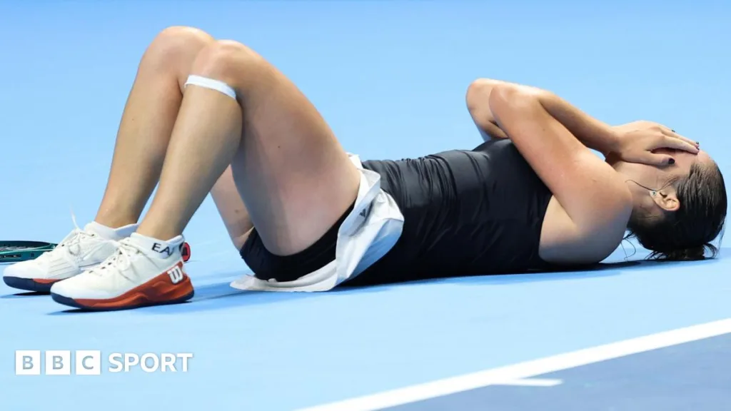 Italy's Elisabetta Cocciaretto throws herself to the floor after victory in her Billie Jean King Cup quarter-final against China