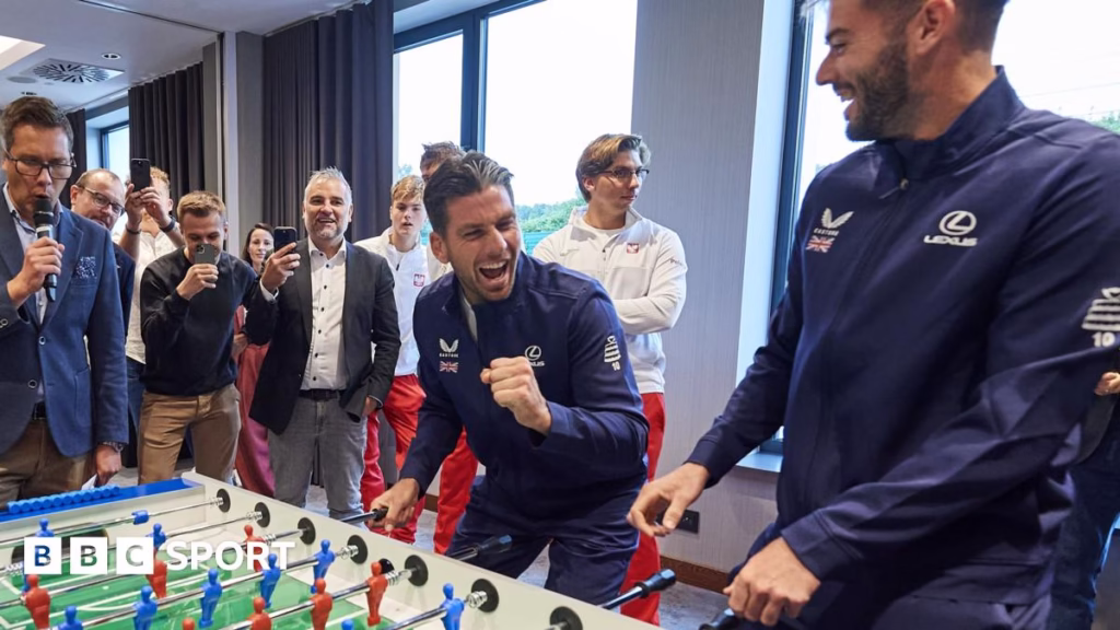 Cameron Norrie and Jacob Fearnley laughing while playing table football