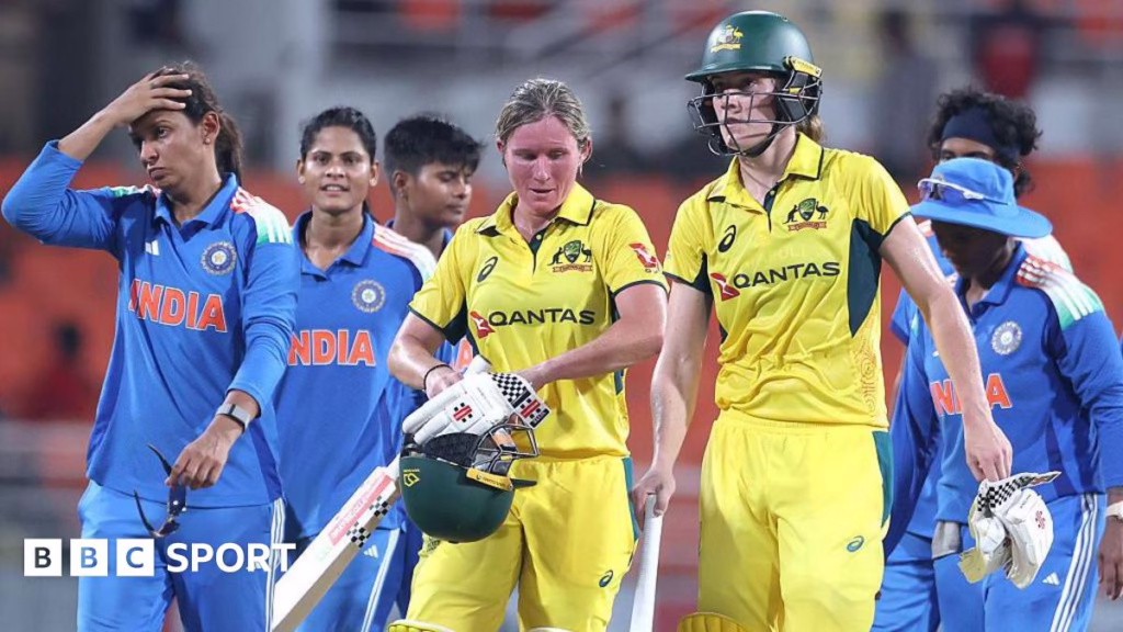 Beth Mooney and Annabel Sutherland of Australia leave the field after beating India in the first one-day international