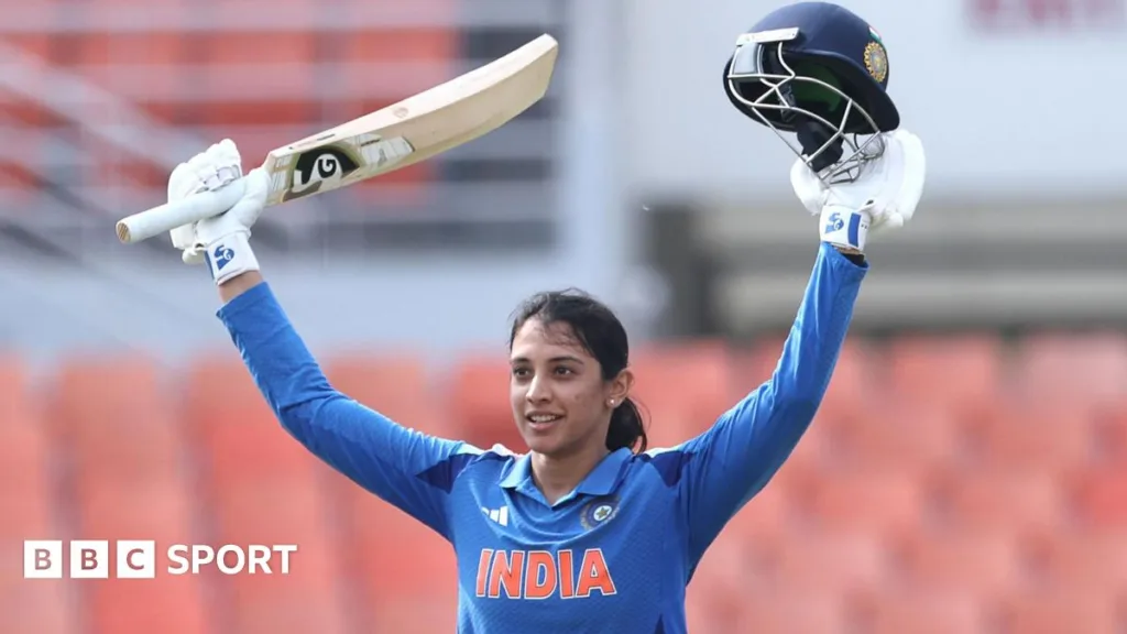 India's Smriti Mandhana raises her bat after reaching an ODI century against Australia at New Chandigarh