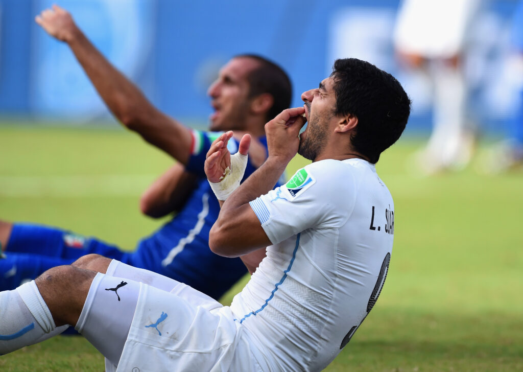 Luis Suarez of Uruguay reacts after biting Giorgio Chiellini of Italy at the 2014 FIFA World Cup