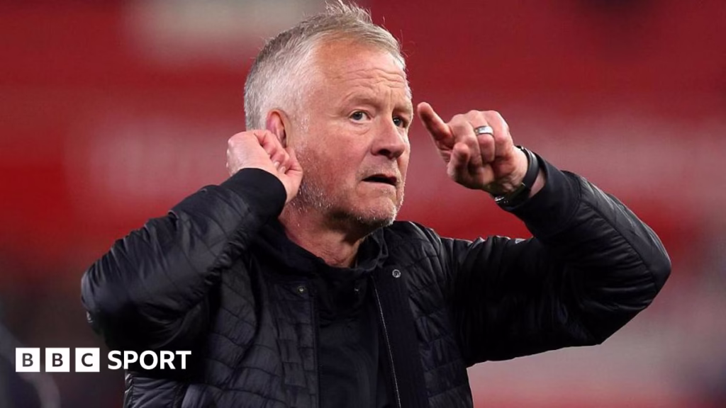 Chris Wilder cups his ear to the crowd
