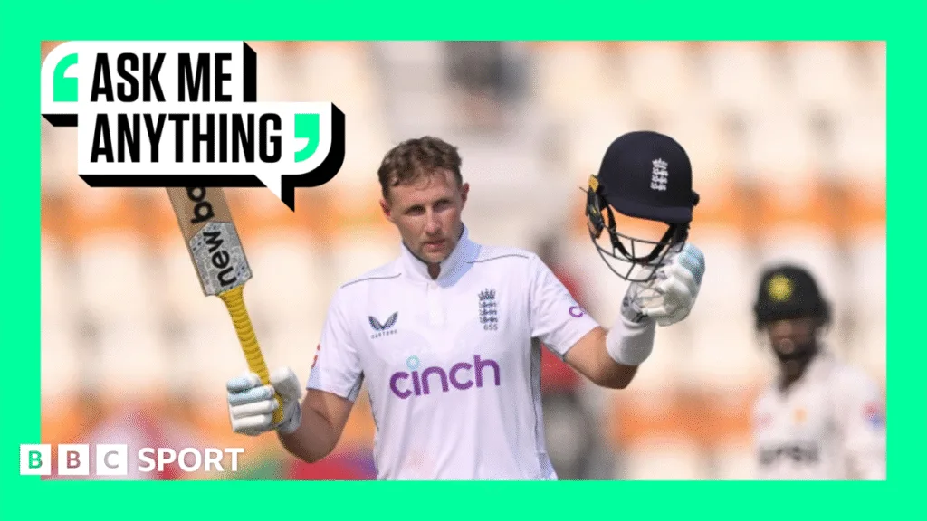 Joe Root holds his bat and helmet aloft in celebration